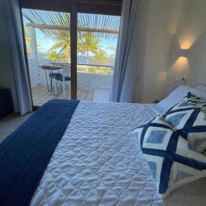 1 dormitorio con 1 cama y vistas a la playa en Aldeia Coqueiral, en Caraíva