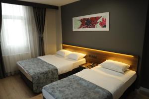 Postel nebo postele na pokoji v ubytování Turkuaz Hotel + 29 fotografií