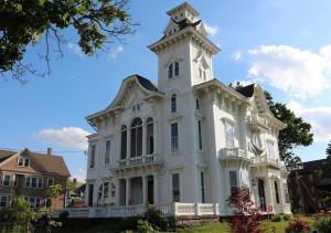 a white house with a tower on top of it at The Wedding Cake House in Providence