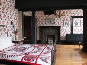 a bedroom with a bed and a fireplace at The Wedding Cake House in Providence