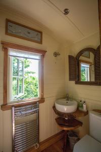 a bathroom with a sink and a window at the abberton shepherds hut in Evesham