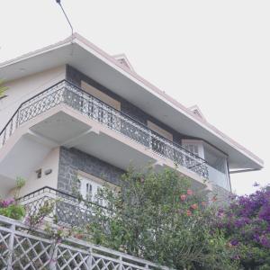 a house with balconies on the side of it at Hotel Temple Towers in Kodaikānāl