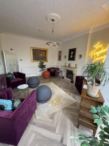 a living room with a purple couch and a table at The Bishop and The Bison in York