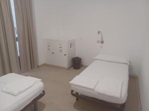 Postel nebo postele na pokoji v ubytování PALACIO REAL HOSTEL