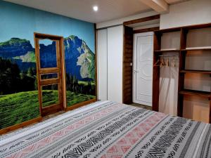 ein Schlafzimmer mit einem Wandbild mit Bergblick in der Unterkunft HillView Studio in La Trinité
