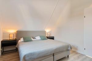 Postel nebo postele na pokoji v ubytování Villa Vermeer