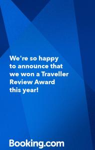 a blue sign that says were so happy to announce that we won a traveler at Highfield 2 rooms Apartment in Augsburg