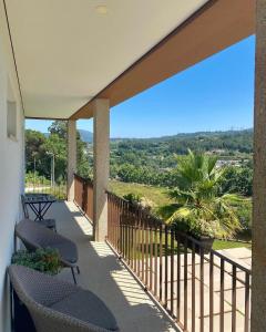 a balcony with chairs and a view of the mountains at Casa D' Almeidas in Amares