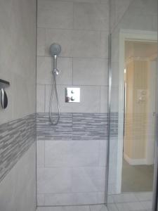 a shower with a glass door in a bathroom at Daisychain Holidays in Bridlington