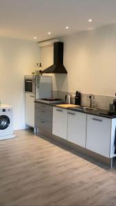 a kitchen with a sink and a stove top oven at loods 14-2 in Groningen