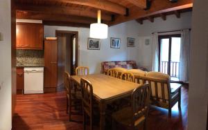 - une cuisine et une salle à manger avec une table et des chaises dans l'établissement Apartament Dúplex de Can Bota Avet-p, à Setcases