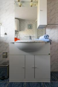 a bathroom with a sink and a white cabinet at Villa Marcelina in Seget Vranjica
