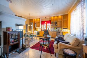 a living room with a couch and a kitchen at Luleå Village Cabin in Luleå