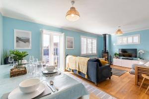 a living room with a couch and a table at Host & Stay - Gorse Cottage in Mundesley