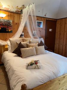 a large white bed with flowers on top of it at Dormi nella SPA privata con letto ad acqua, sauna, doccia emozionale e kneipp in Alessandria