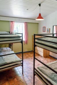 a room with three bunk beds in it at Mehrfamilienhaus auf Fehmarn 800m zum Strand in Fehmarn
