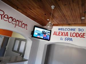 a welcome to alaya lodge and spa sign on a wall at ALEXIA LODGE & SPA in Cape Town