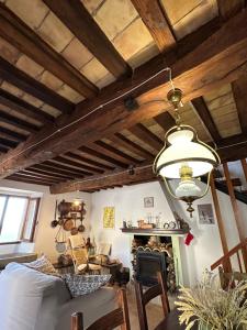 a living room with a ceiling with wooden beams at La Gazza Ladra House in Pieve di Carpegna +24 photos
