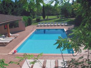 a swimming pool with lounge chairs next to it at Château de la Motte in Marcorignan