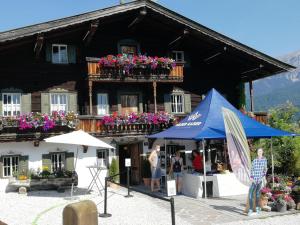 - un bâtiment avec une tente bleue en face dans l'établissement Ferienwohnung Ehrensberger, à Brixen im Thale