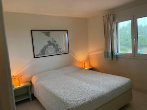 a bedroom with a bed and two lamps on tables at Casa Gallo in Santa Marinella