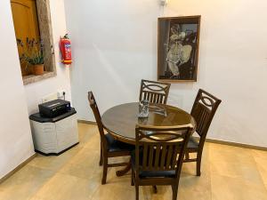 a dining room with a table and four chairs at Boloors sea la vie in Suratakal