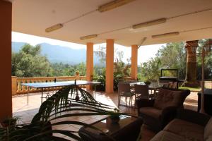 a patio with a table and chairs and a view at Villa Capllonch in Banyalbufar