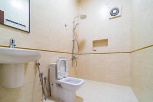 a bathroom with a toilet and a sink and a shower at COMFORT CHALET & APARTMENTS in Al Ḩadd +19 photos