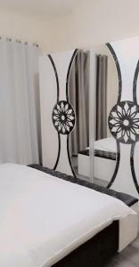 a bedroom with a bed and a mirror at Lemas 1001 in Ajman  +21 photos