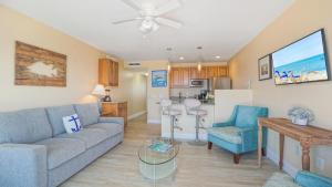 a living room with a couch and chairs and a kitchen at Glunz Ocean Beach Hotel and Resort in Marathon