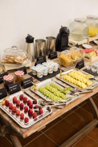 a table with many different types of fruits and vegetables at Hotel Tugasa Convento San Francisco in Vejer de la Frontera