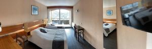 a room with a television and a room with a bed at Logis De La Grande Cascade in Le Tholy +22 photos