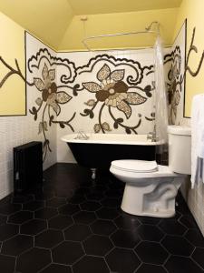 a bathroom with a toilet and a flower shower curtain at The Wedding Cake House in Providence