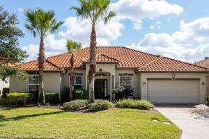 a house with palm trees in front of it at Gorgeous 4Bd Close to Disney w/ Pool @ 4072 Solterra Resort in Davenport