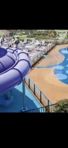 a purple water slide at a water park at 3 bedroom luxury caravan haven, marton mere in Blackpool