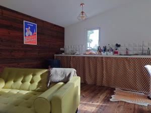 a living room with a couch and a counter at Un chalet au Ventoux - Mont Serein in Mont Serein