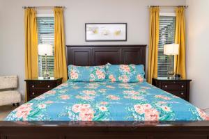 a bedroom with a bed with a blue comforter at Gorgeous 4Bd Close to Disney w/ Pool @ 4072 Solterra Resort in Davenport