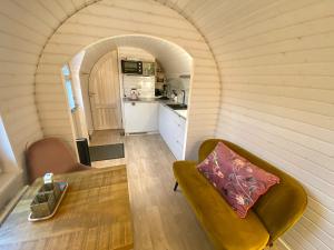 a small living room with a couch and a table at Bed & Wellness Pigs and Pillows with private hottub and sauna and tandembike rental included in price near Amsterdam in Almere
