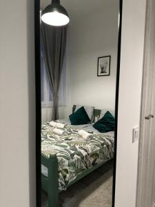 a mirror reflection of a bed in a bedroom at Dolce Vita Budapest in Budapest