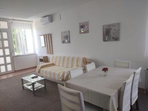 a living room with a table and a couch at Apartment Marija in Slavonski Brod