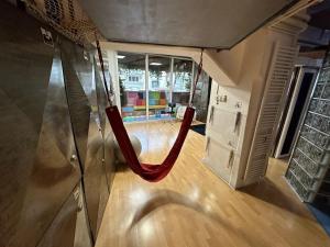 a red hammock in the middle of a room at Athens centre diamond in Athens