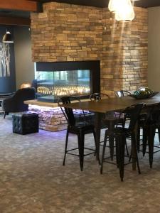 a dining room with a table and chairs and a fireplace at The Lodge at Wisp in McHenry