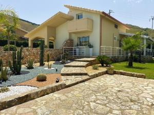 a house with a stone walkway in front of a yard at Borgo Aranci - Appartamento in Villa Orchidea - 12A in Castellammare del Golfo