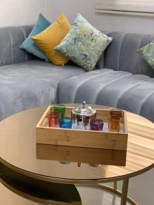 a wooden tray on a table in front of a couch at Most Beautiful Apartment in Safi in Safi