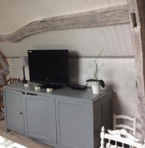 einen Fernseher auf einem Schrank in einem Zimmer in der Unterkunft Les Songes de l'Authie in Boufflers
