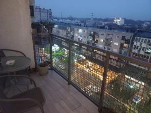 a balcony with a view of a city at night at Apartman Mihajlovic in Bijeljina