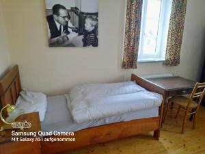 a bedroom with a bed and a desk with a child at Landhaus Just in Maria Elend