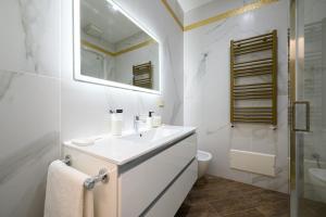 a bathroom with a sink and a toilet and a mirror at Villa In Bed in Naples