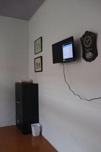 Pokój z telewizorem na białej ścianie w obiekcie HW. Hubers Hotel, Bar & Resto w mieście Laguboti