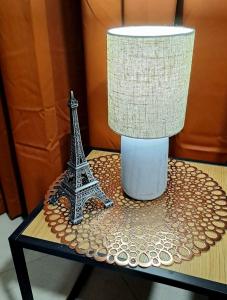 a table with a lamp and a statue of the eiffel tower at Студио Цвят/ Studio Colour in Blagoevgrad